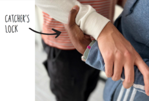 close-up of two people clasping each other's arms under the elbow